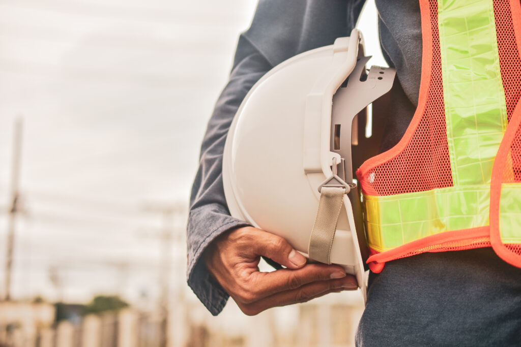 Technician holding white hat safety hard hat sunlight background